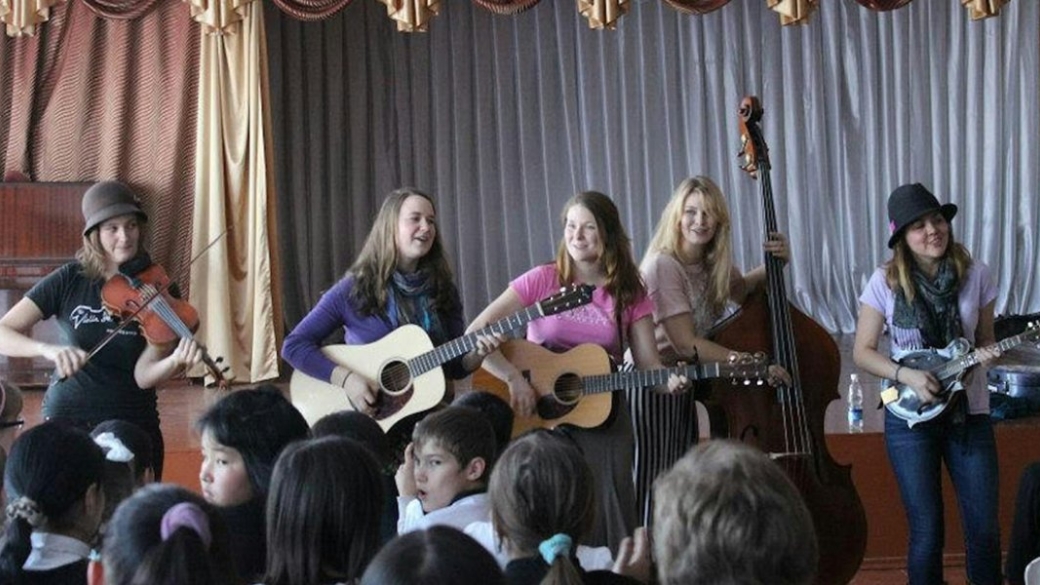 The bluegrass group Della Mae plays at an orphanage in Kyrgyzstan on its State Department-sponsored American Music Abroad tour in 2012. Photo: Paul Rockower