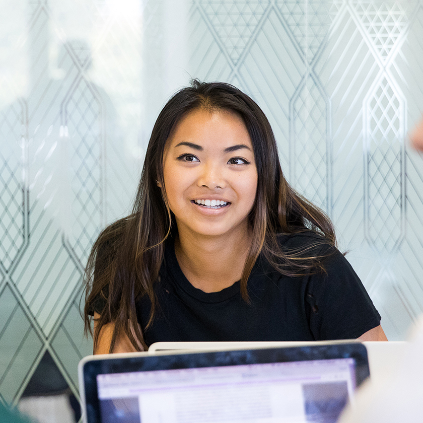 Journalism student working at a desk at USC Annenberg