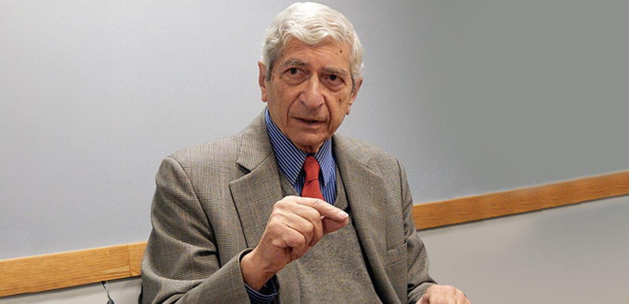 Photo of Marvin Kalb in a classroom setting dressed in a suit