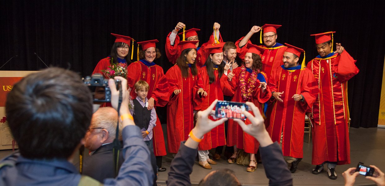 Ph.D. graduates pose for photographs for their family and friends after receiving their degrees on May 14, 2105 at the USC Annenberg School for Communication Doctoral Hooding Ceremony.