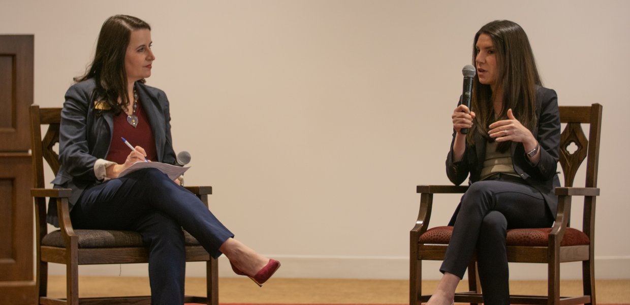 two women seated and mid conversation