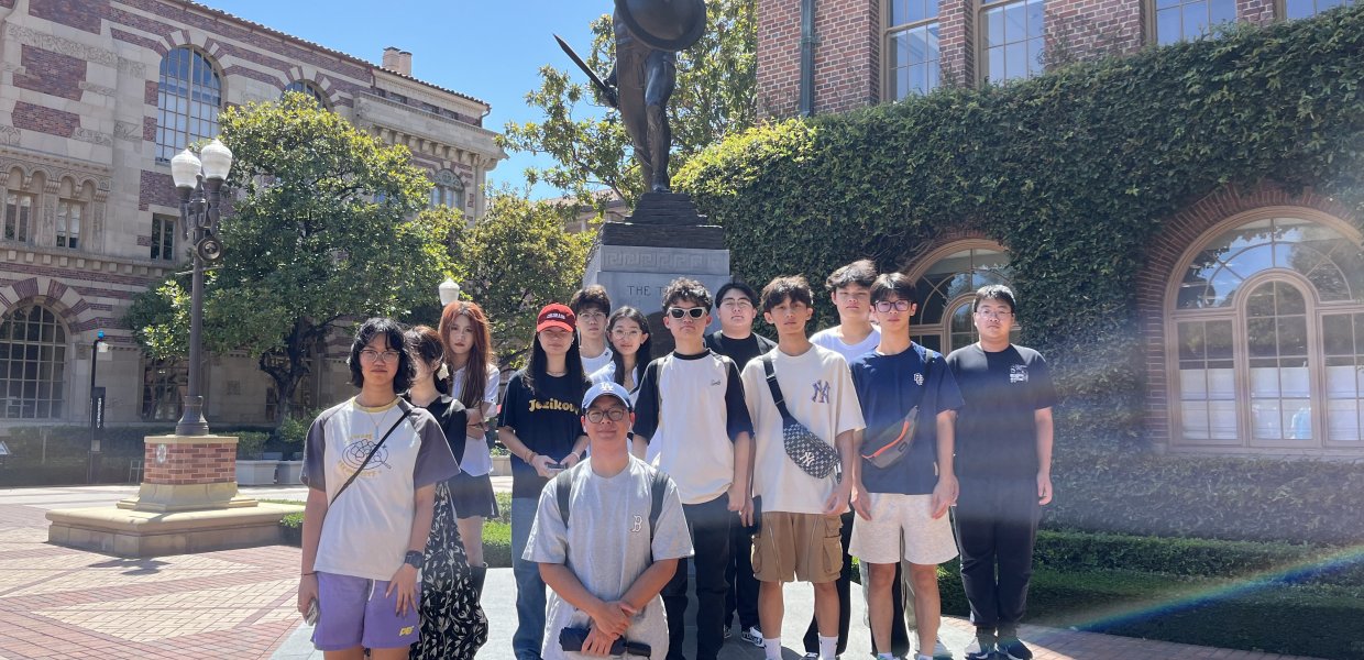 Photo of a group of students by a statue