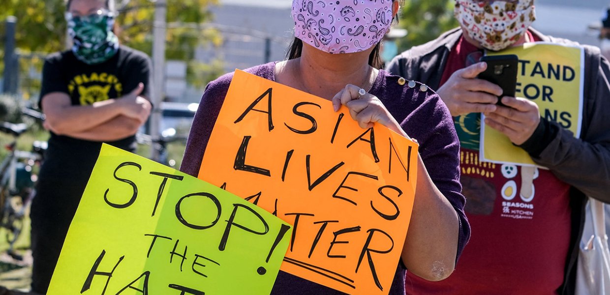 Image of Los Angeles rally where people hold signs that read "Stop the Hate!" and "Asian Lives Matter"
