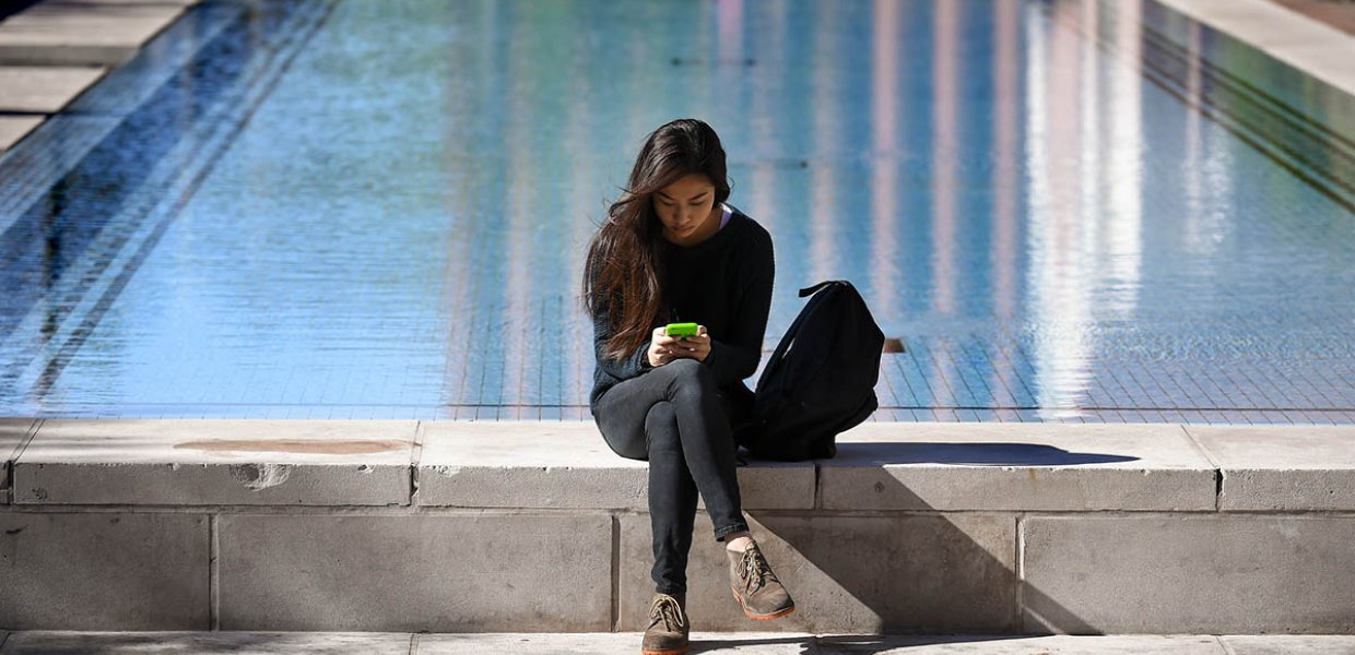 Photo of a person sitting by a pool