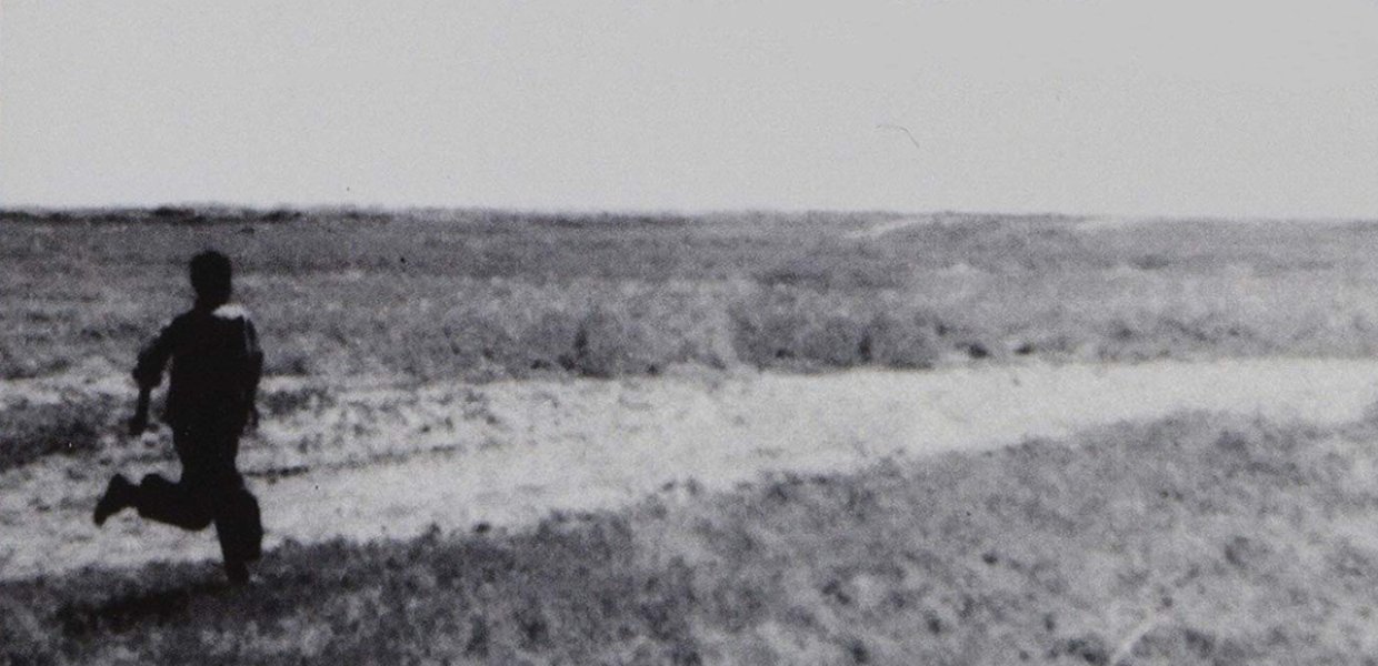 Photo of a person running near the sea