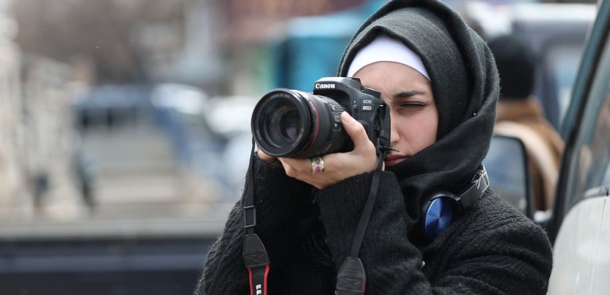 Woman taking photograph.