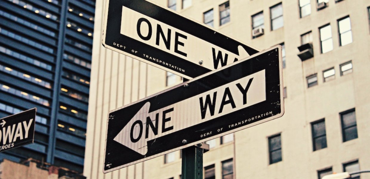 Photo of one way signs on a street