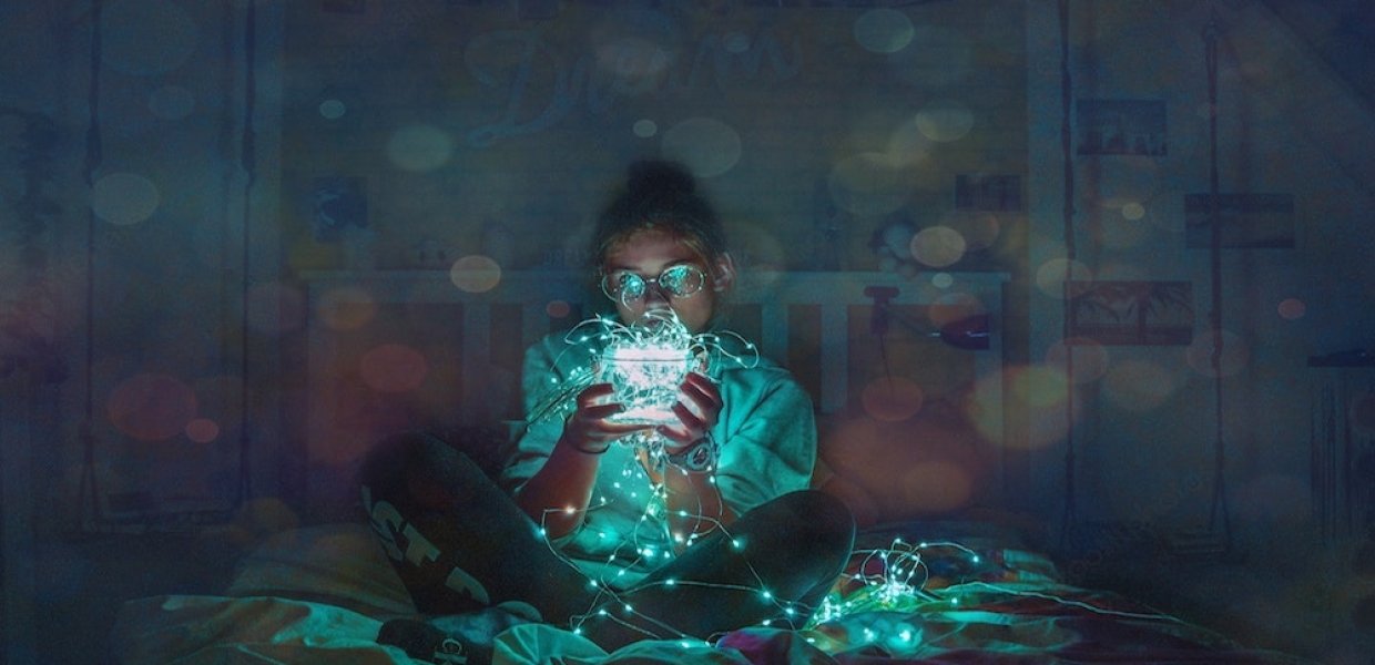 Photo of a person holding a ball of string lights