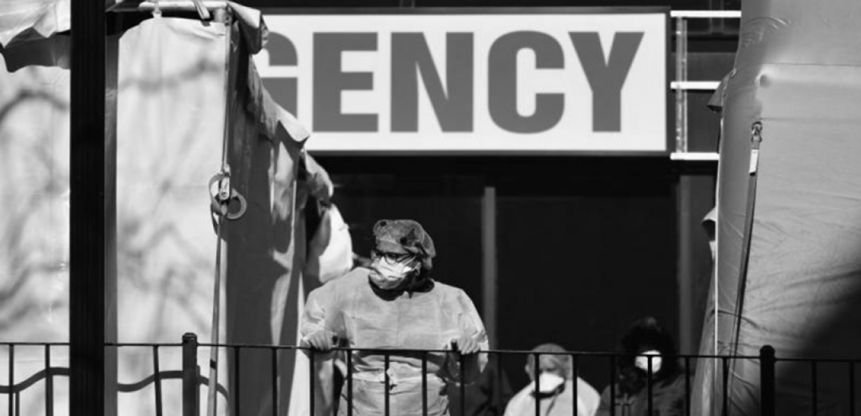 Photo of a person wearing PPE outside a building