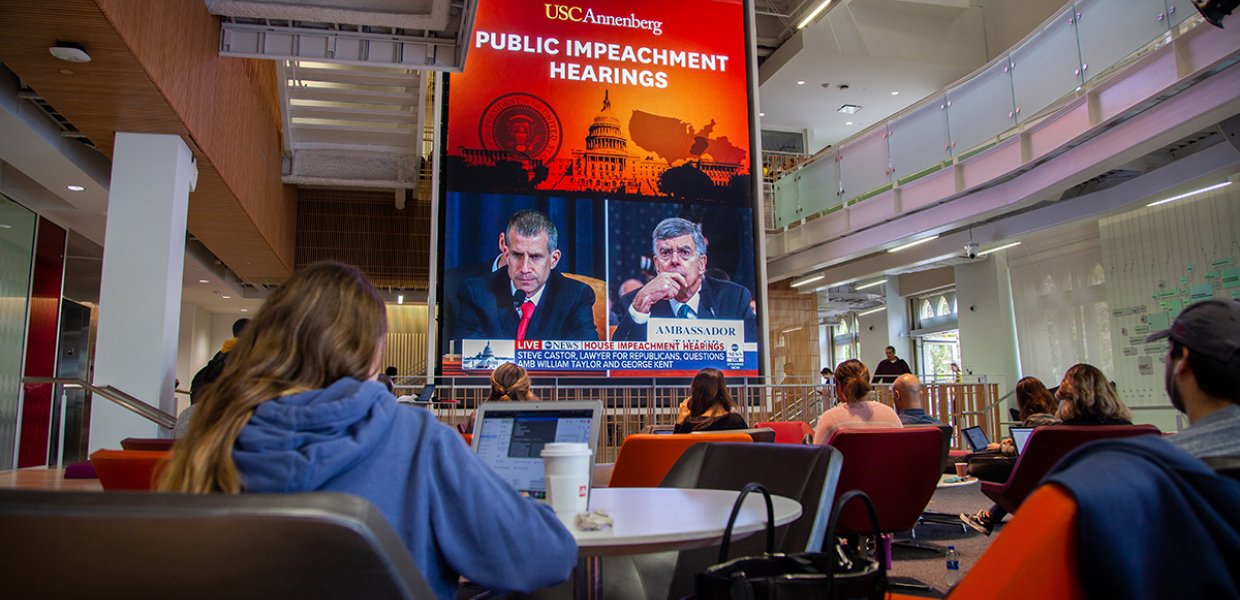 Photo of people watching the public impeachment hearings in USC Annenberg