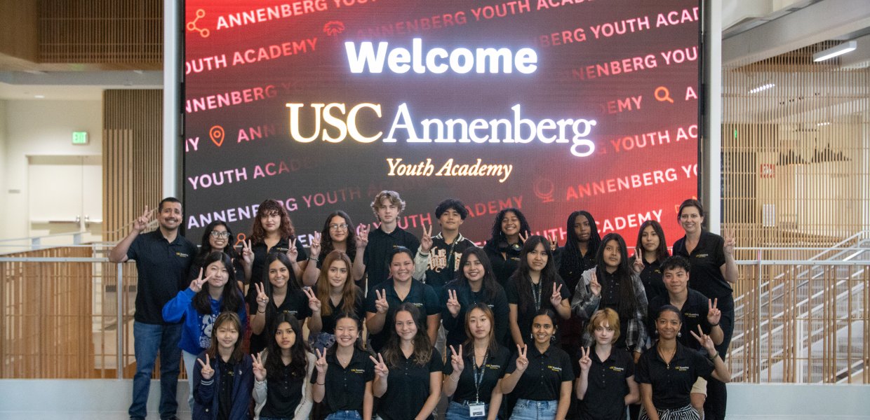 group photo of 25 high school students and two instructors wearing black t-shirts