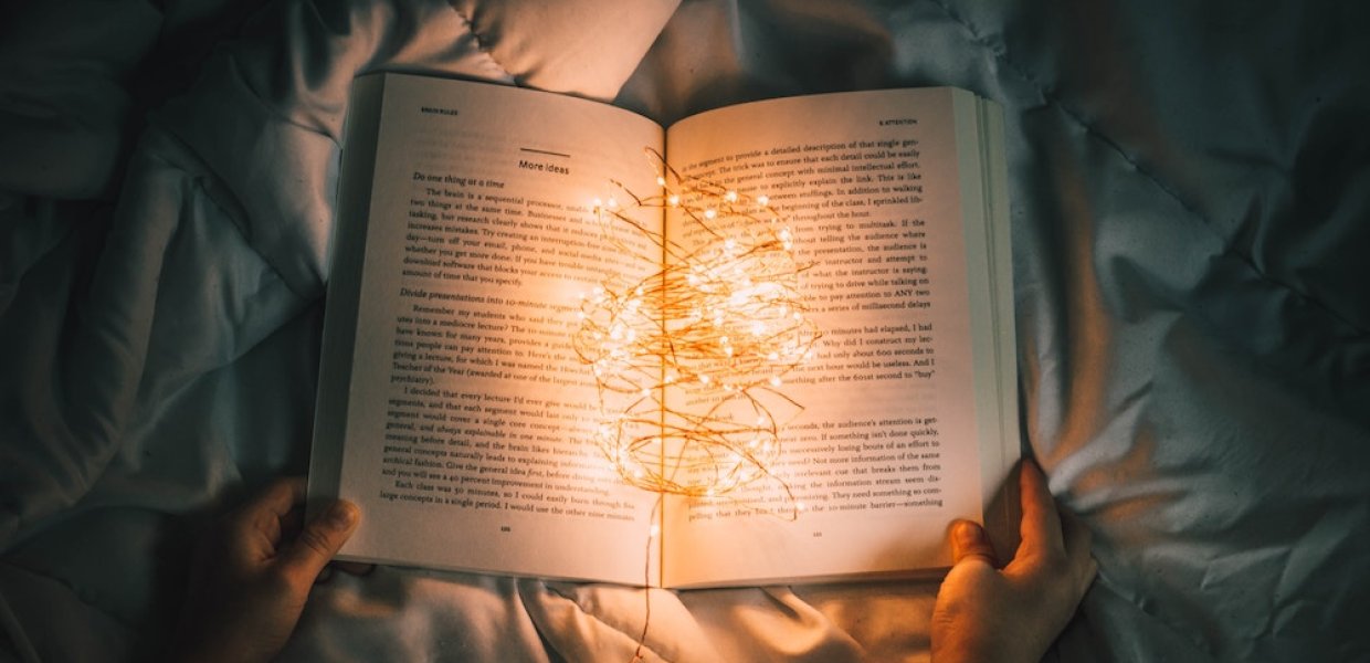Photo of an open book with a string of lights in it