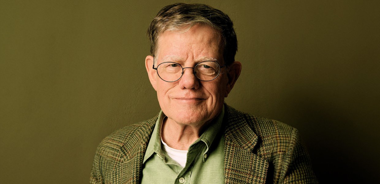 Male in green shirt and blazer wearing glasses