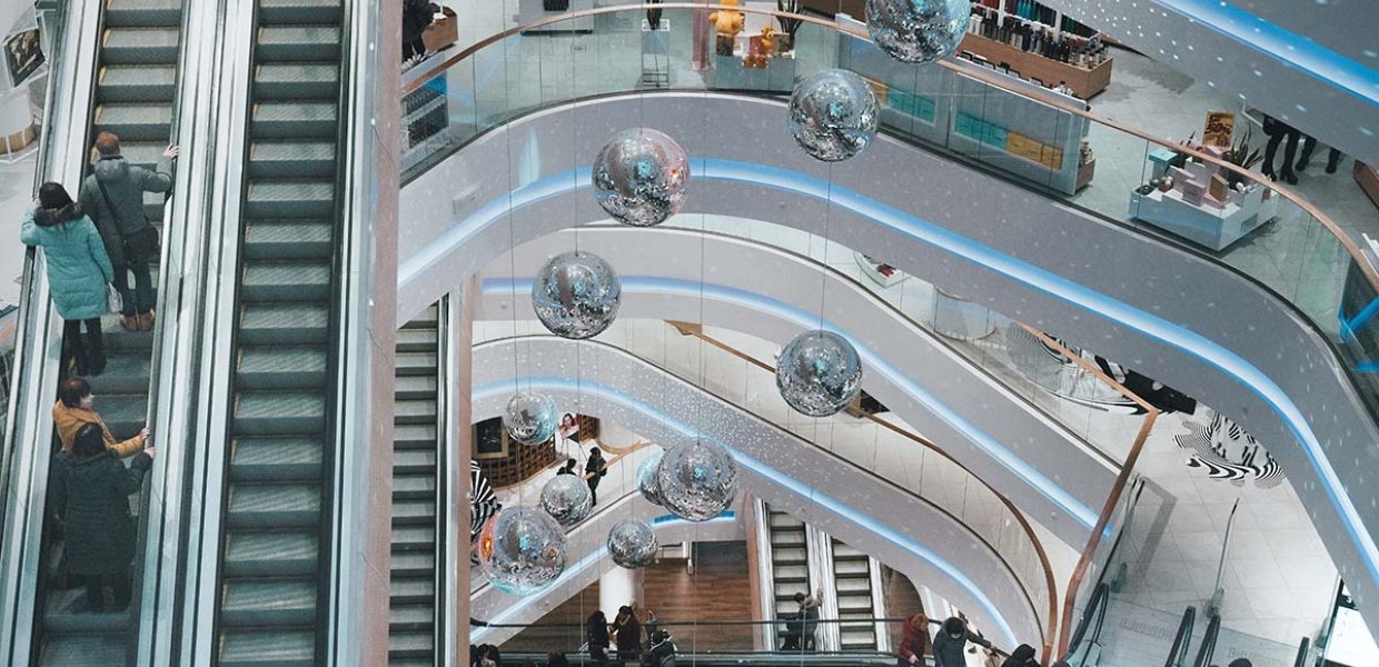 Photo of a retail shopping center displaying an escalator and many levels