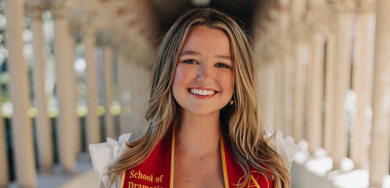 Tess Patton smiles for camera wearing USC graduation stole