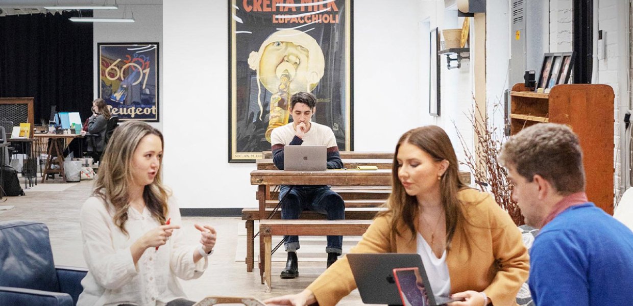 Photo of people collaborating and working on laptops. 