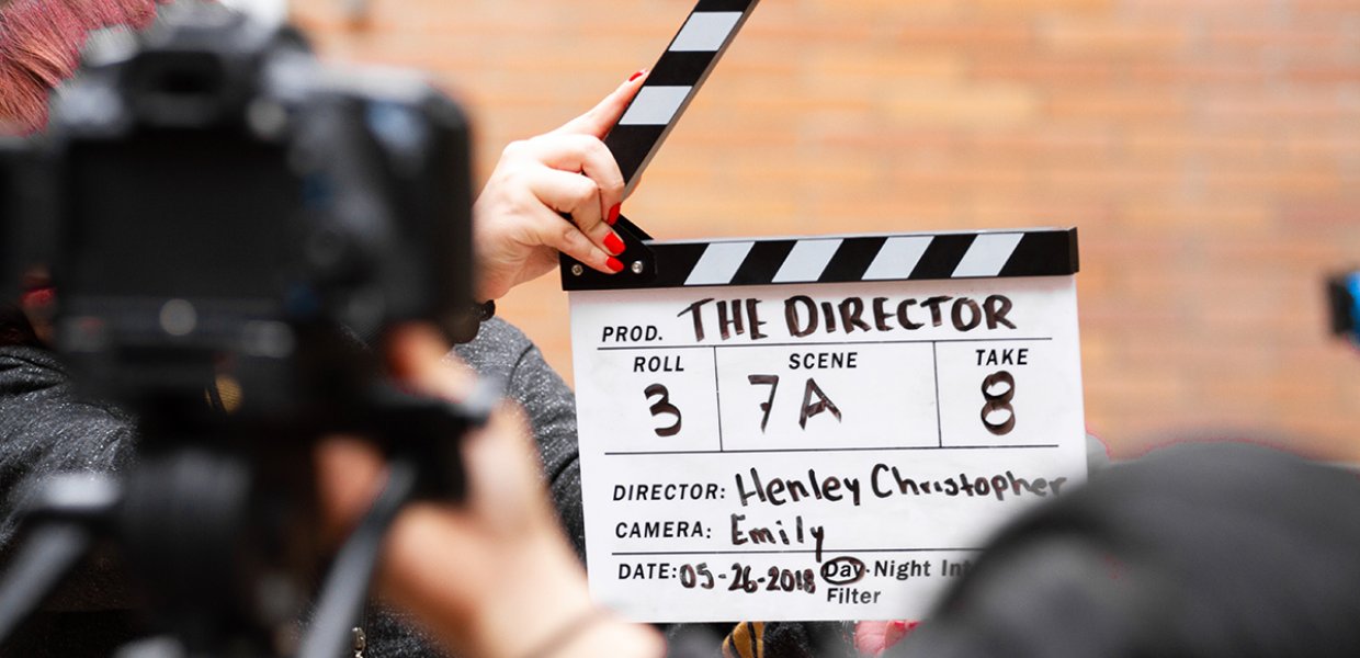 Photo of a person holding a movie clapperboard