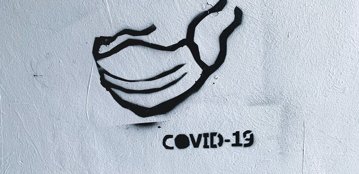Painting of a face mask with the words COVID-19 under it
