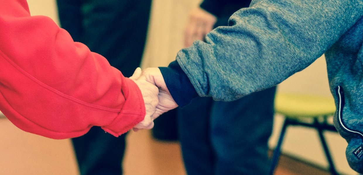 Photo of two people holding hands