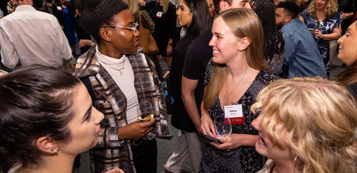 Chelsea Burnside, along with other alumni, networking at the 2023 USC Annenberg New York City Maymester reception.