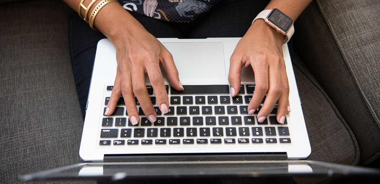 Photo of a person typing on a keyboard