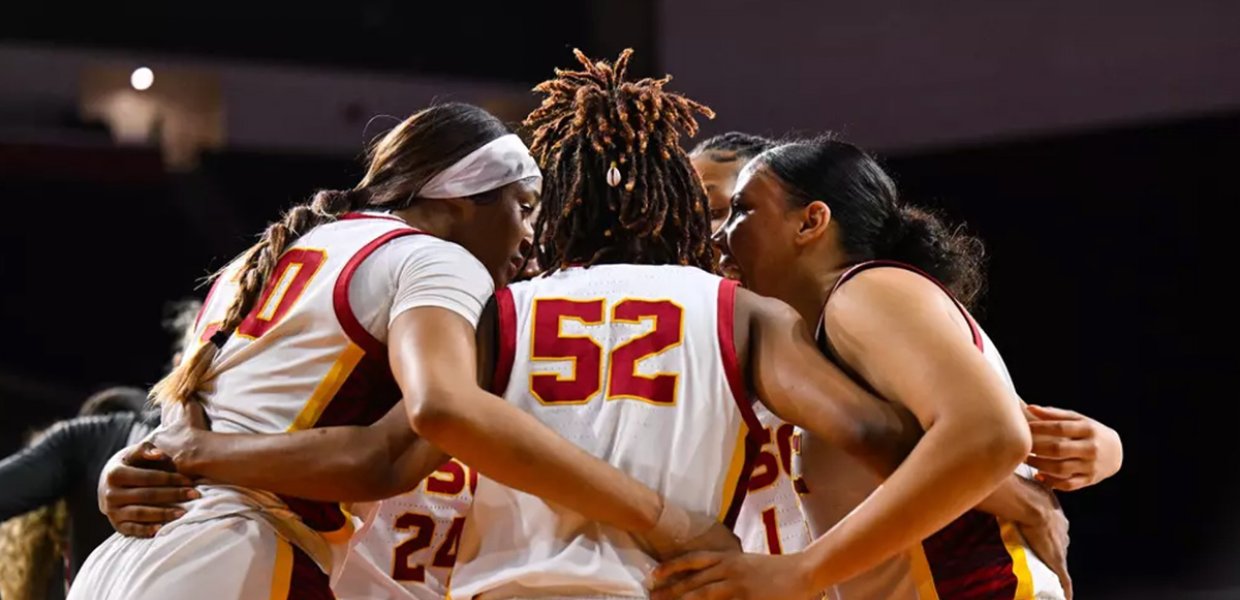 Women's basketball players for USC, hugging.