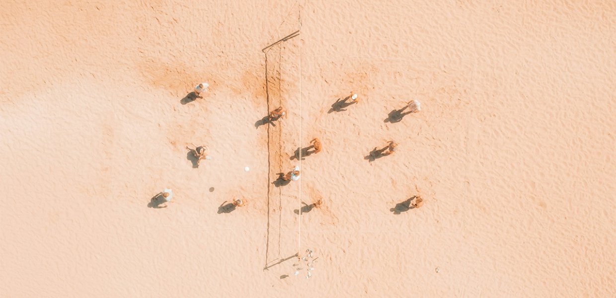 An overhead shot of people playing beach volleyball
