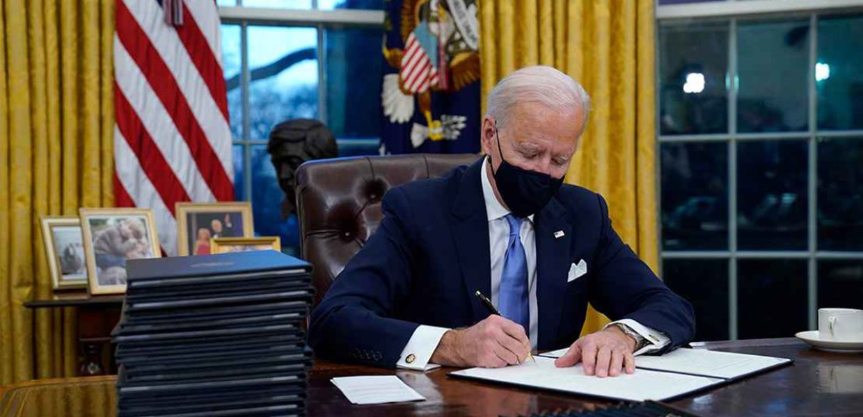 Photo of Biden signing an executive order