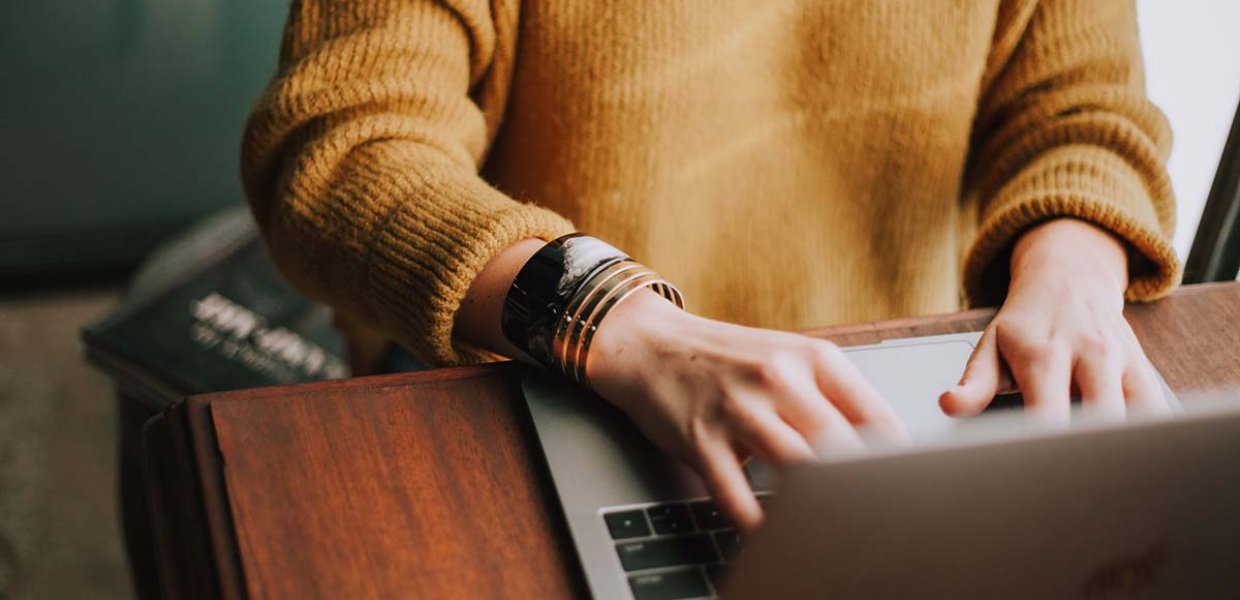 Image of a person typing on the computer