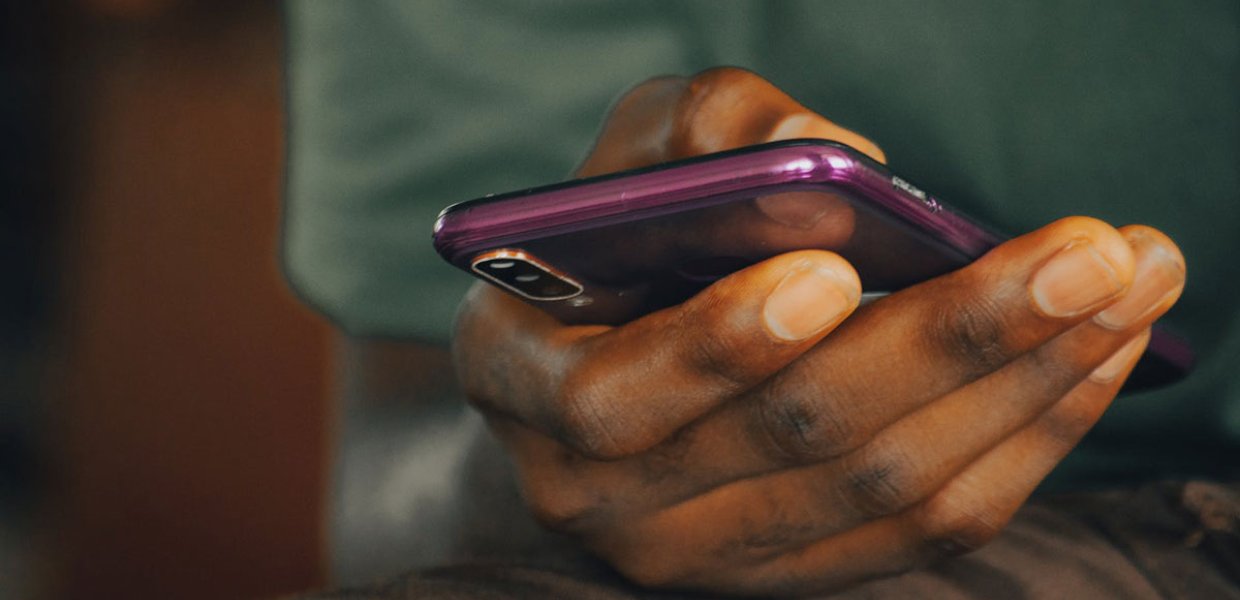 Photo of a person holding a mobile phone
