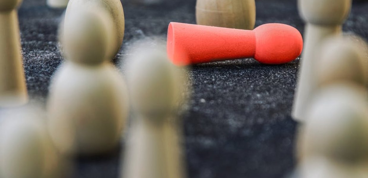 Photo of a game where many figures are standing up and one is knocked over