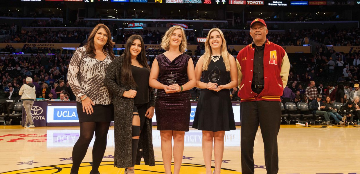 From let to right: Shannon Hearn, Kayla Hearn, Jodee Storm Sullivan, Keely Eure, and USC Annenberg School for Communication and Journalism Dean Ernest J. Wilson III, Ph.D., pose for a photo during the halftime of the Lakers - Hawks game. The Hearns and La