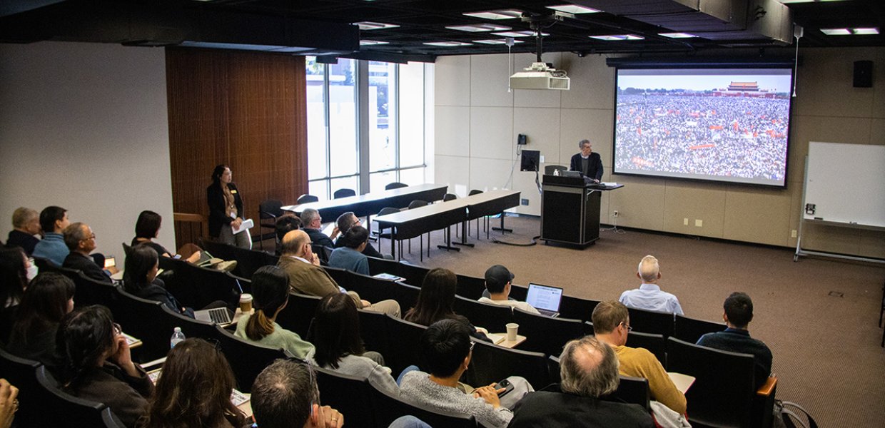 A man addressing a classroom full of people