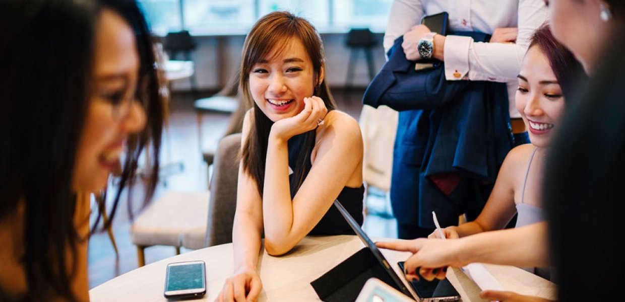 Photo of people conversating around a table