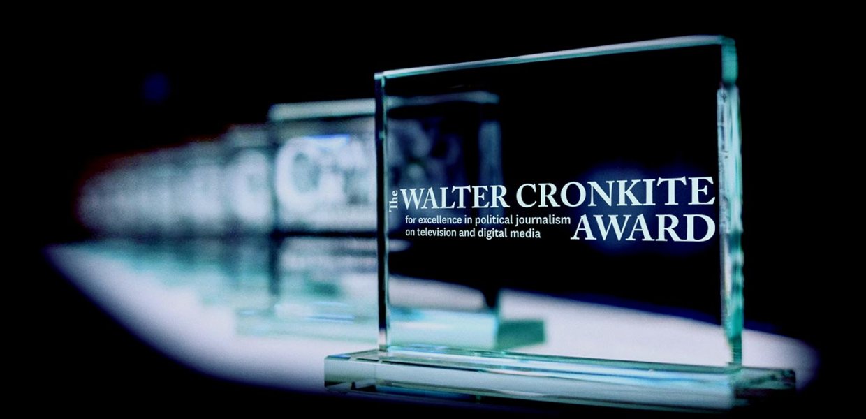 Glass awards extend back into a black background.