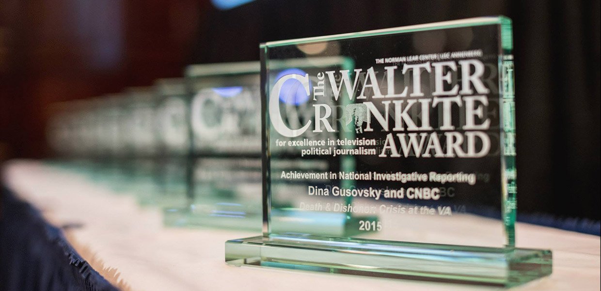 rectangular shaped glass awards lined up in a row with the words Walter Cronkite Award written on them