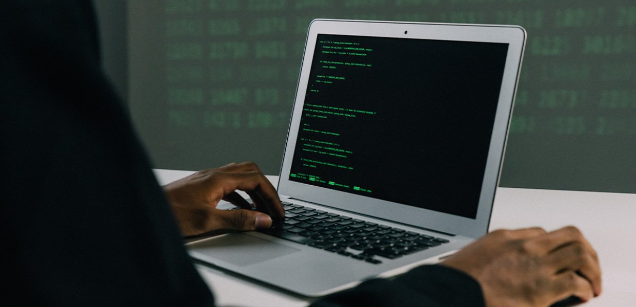A photo of a laptop with code on the screen.
