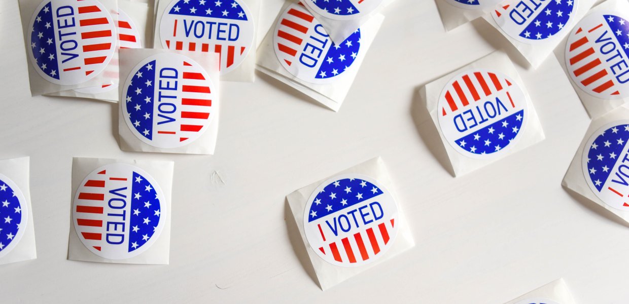 Photo of many I Voted stickers on a table