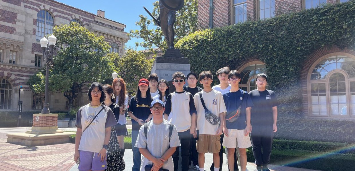 Photo of a group of students by a statue