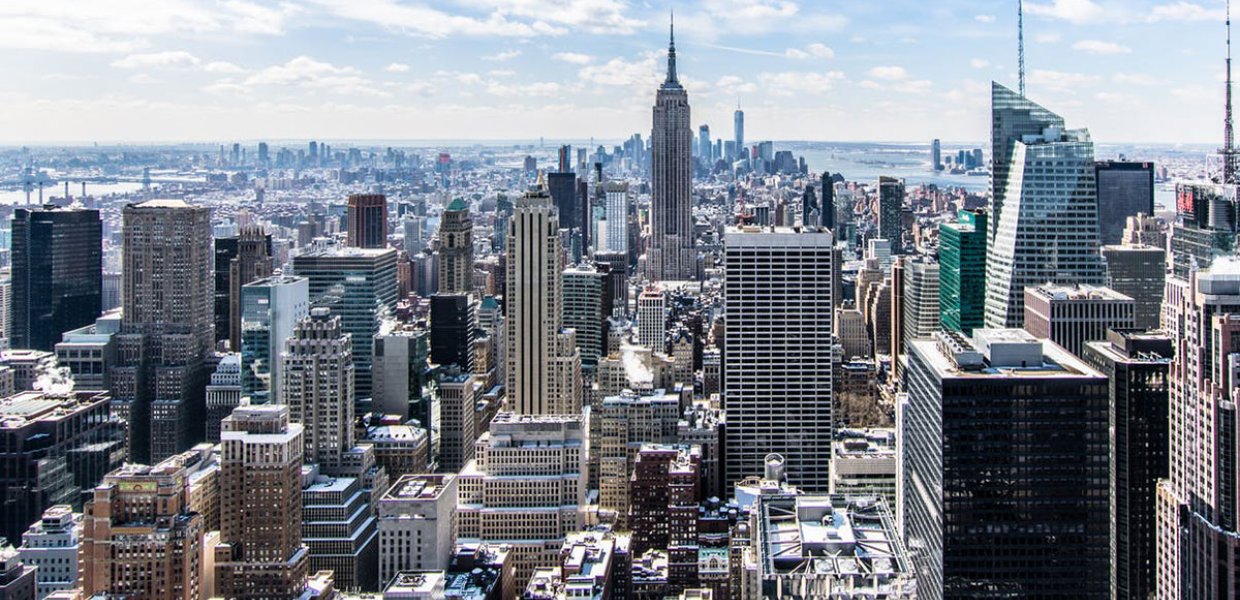 Photo of the Empire State Building in New York City, NY amongst many other buildings