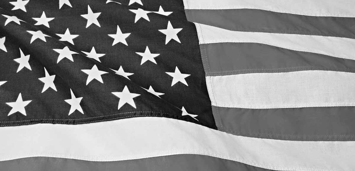 Black and white photo up close of the American flag