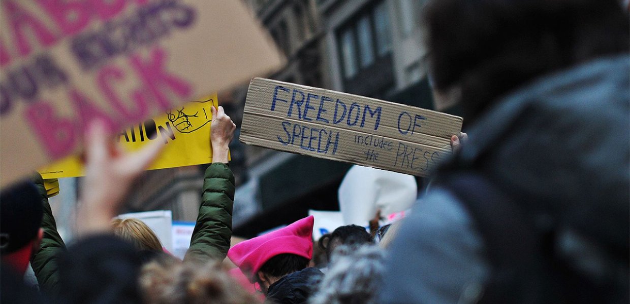 A sign that reads "Freedom of speech" at a protest.