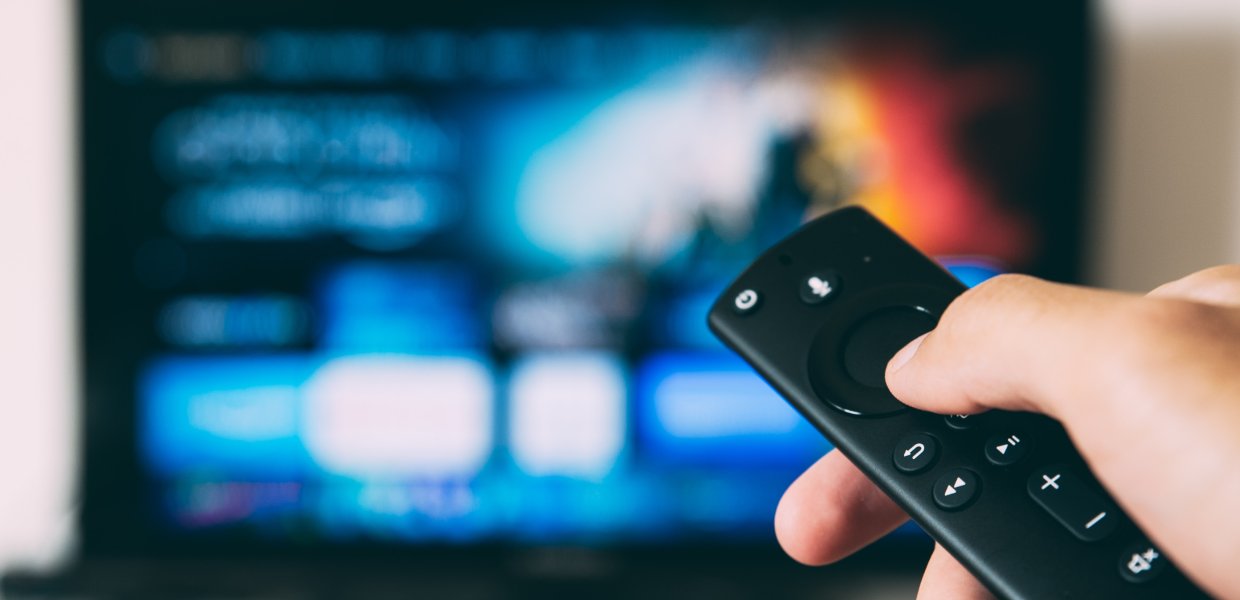 Photo of a person using a television remote