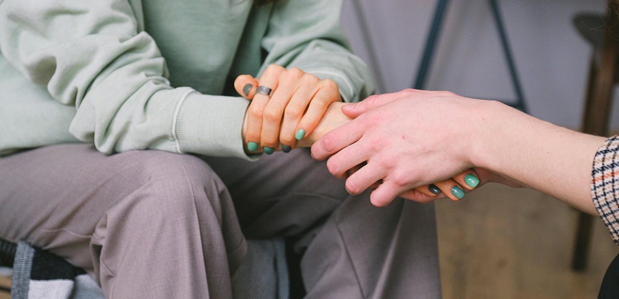Crop psychologist supporting patient during counseling indoors