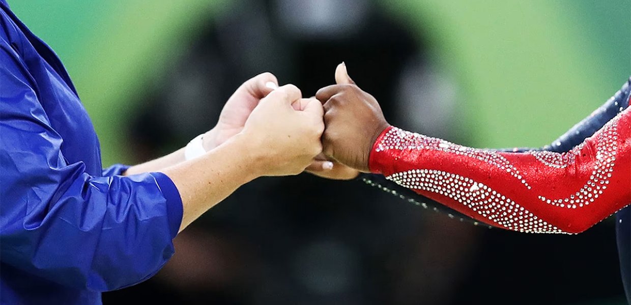 Two Olympic athletes fist bump 