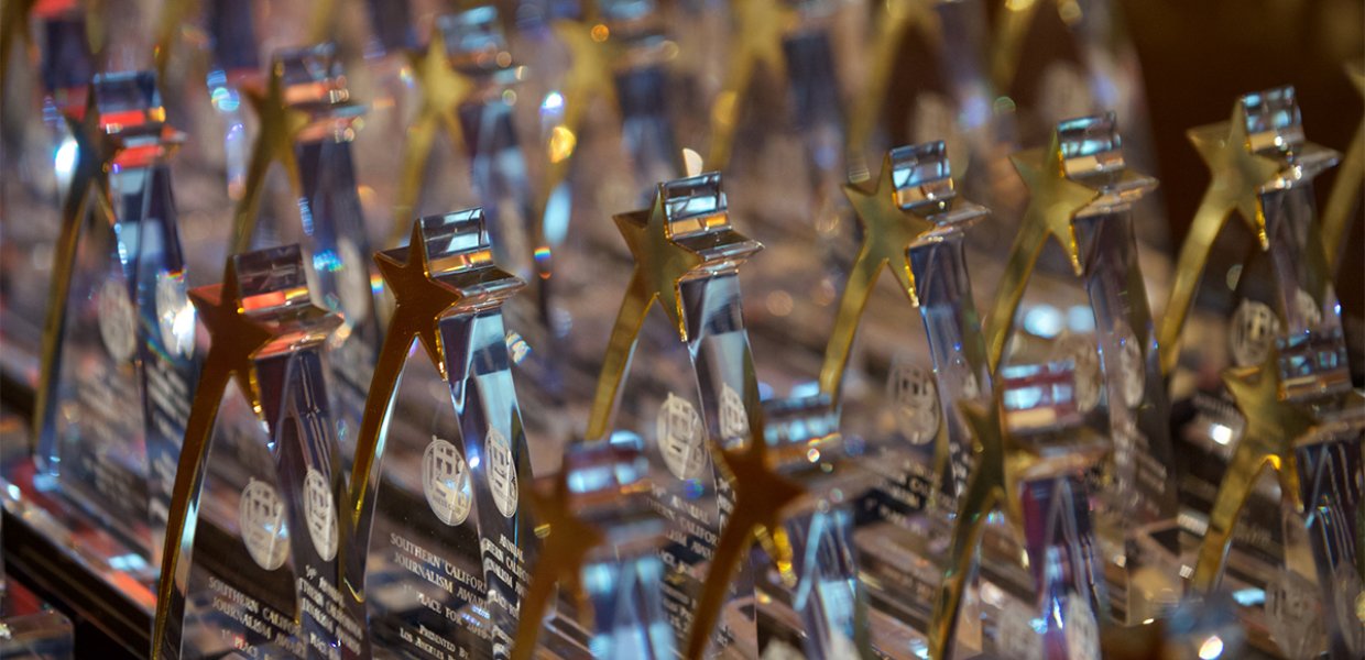 Photo of many awards lined up together
