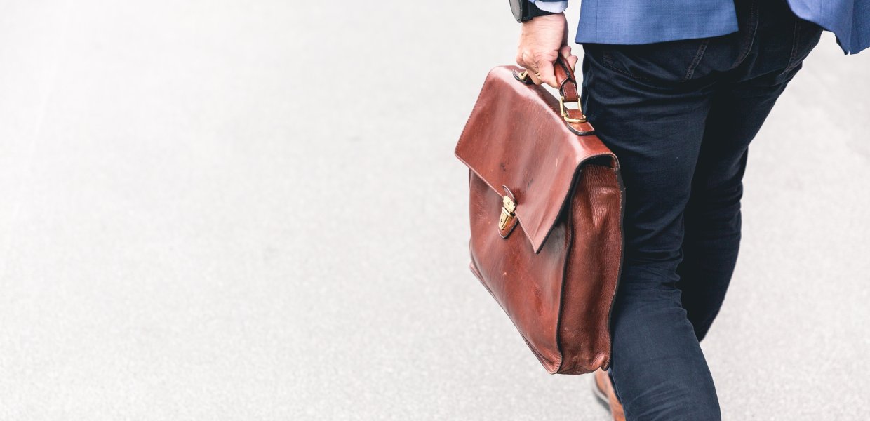 Photo of a person carrying a leather briefcase
