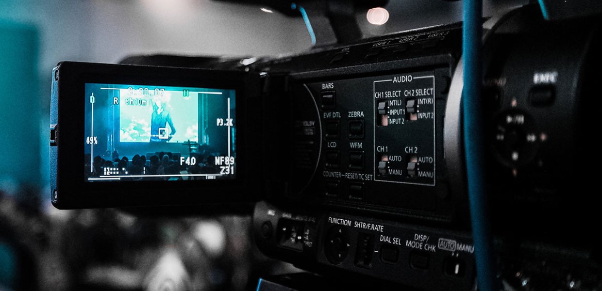 Photo of a black camera recording a film event