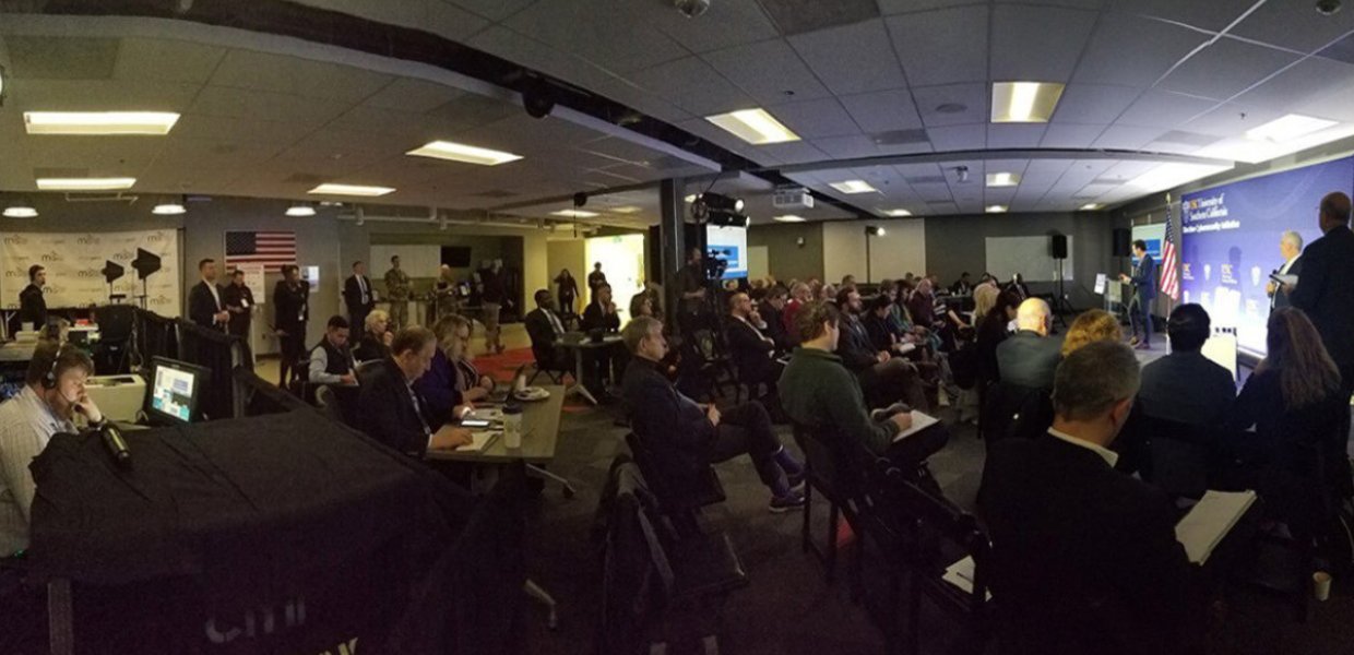 A classroom full of people facing a presentation