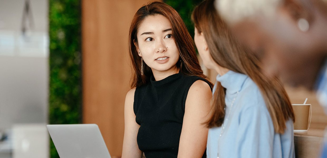 Photo of two people speaking to eachother